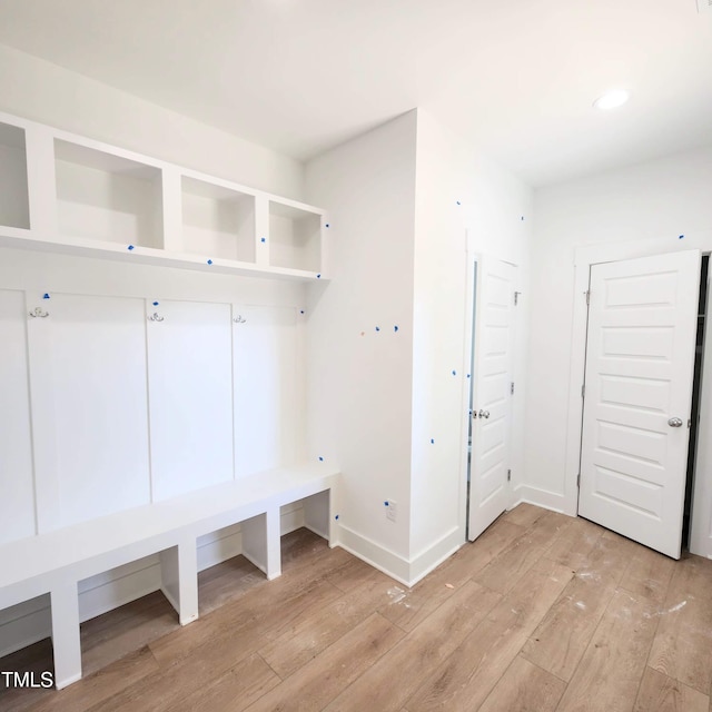 mudroom featuring light wood-style floors and baseboards