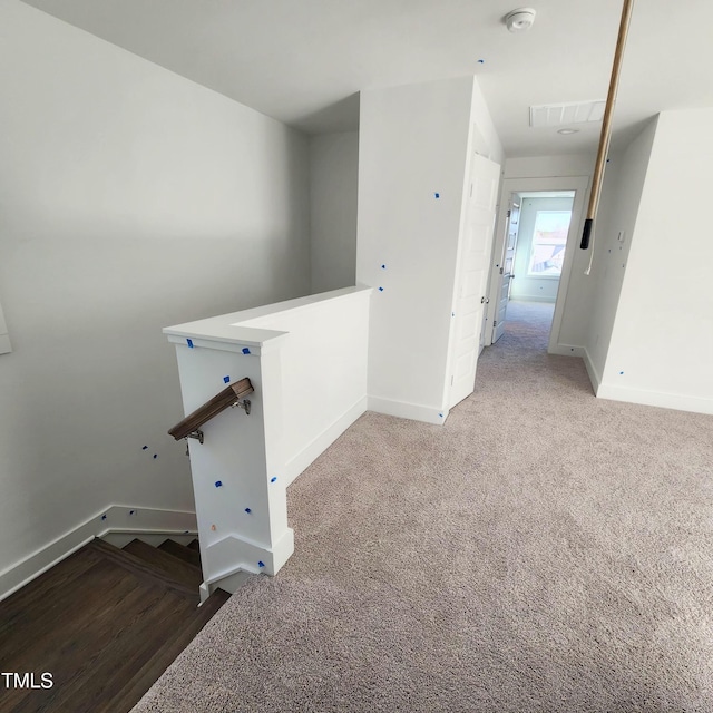 interior space featuring visible vents, baseboards, and carpet flooring