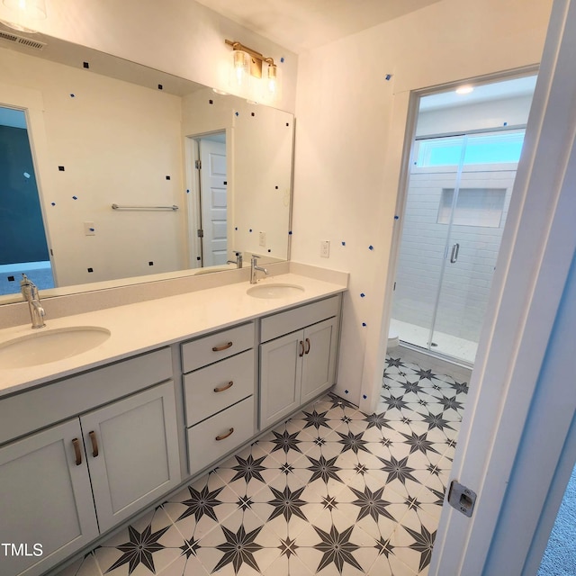 full bath featuring a sink, visible vents, a shower stall, and tile patterned floors