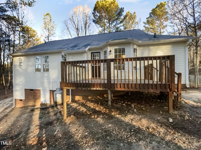 rear view of house featuring a wooden deck