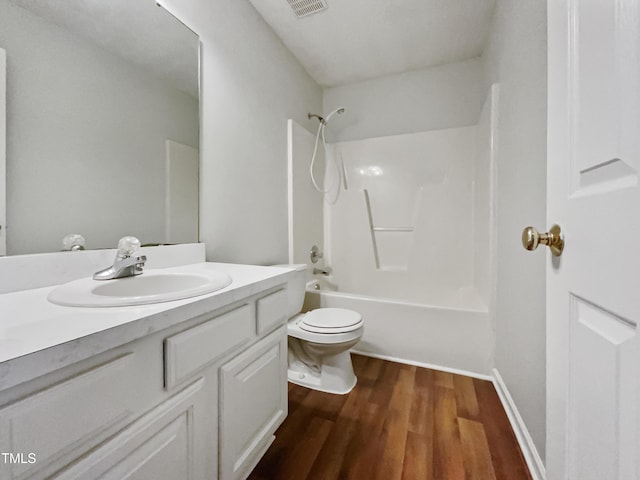 full bathroom with toilet, vanity, bathtub / shower combination, and hardwood / wood-style floors