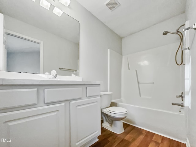 full bathroom featuring hardwood / wood-style flooring,  shower combination, toilet, and vanity