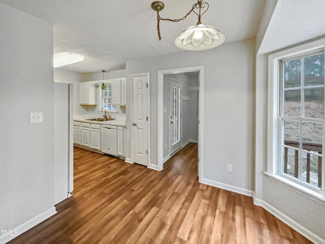 unfurnished dining area with sink and light wood-type flooring