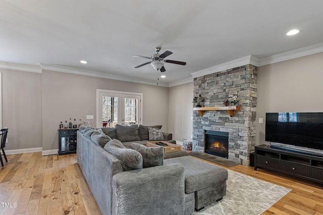 living room featuring french doors, crown molding, and light hardwood / wood-style flooring