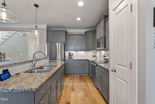 kitchen with pendant lighting, sink, gray cabinetry, and appliances with stainless steel finishes