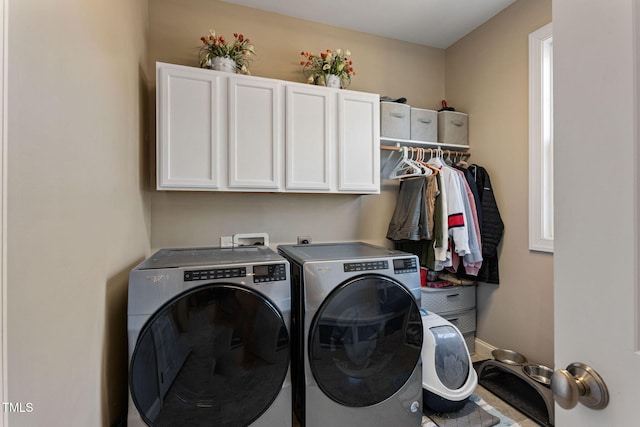 laundry area with cabinets and separate washer and dryer