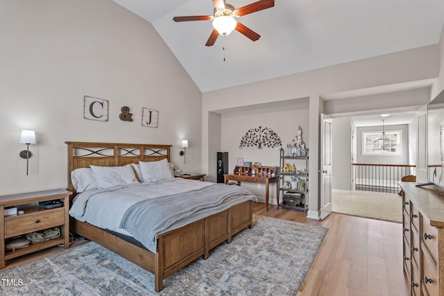 bedroom with high vaulted ceiling, light hardwood / wood-style floors, and ceiling fan