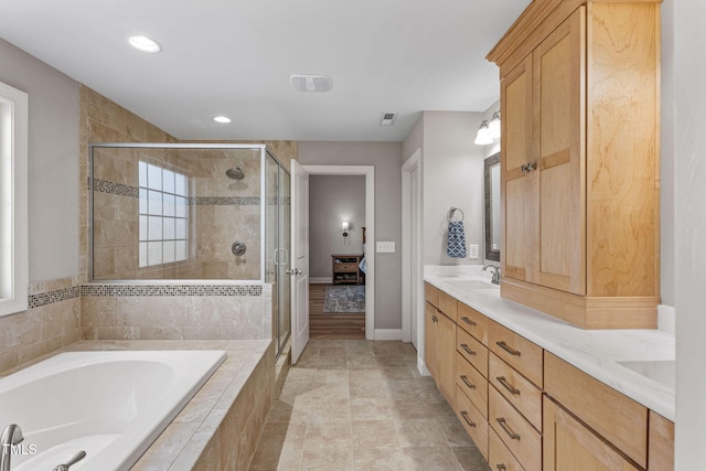 bathroom featuring vanity and shower with separate bathtub