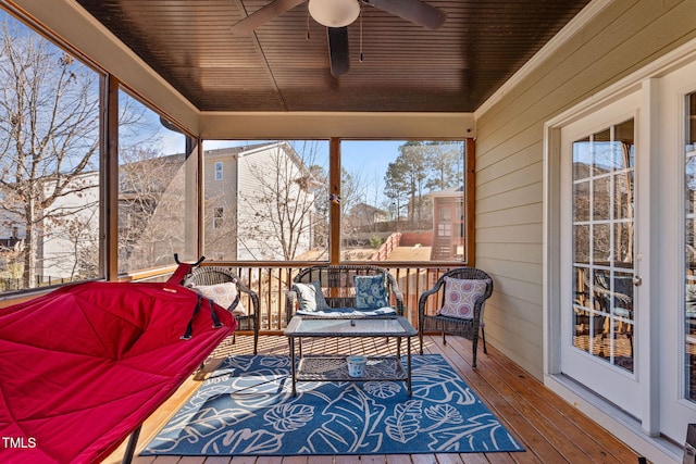 sunroom / solarium featuring ceiling fan