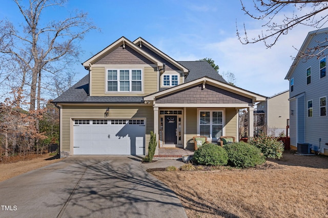 view of front of property featuring a porch, a garage, and central AC unit