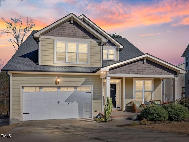 craftsman-style home featuring a garage and covered porch