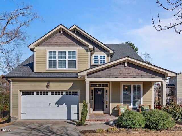 view of front of home with a garage and a porch