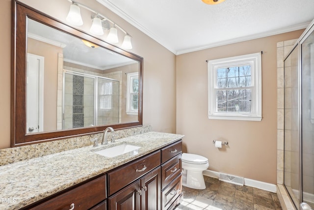 full bath featuring visible vents, a stall shower, crown molding, baseboards, and vanity