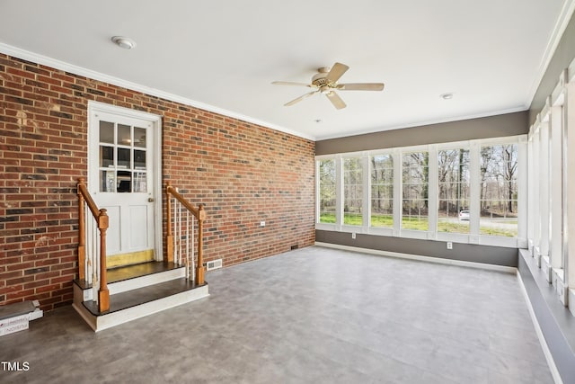 unfurnished sunroom featuring visible vents, brick wall, and ornamental molding