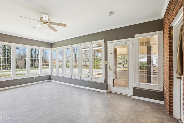 unfurnished sunroom featuring brick wall, baseboards, and ornamental molding