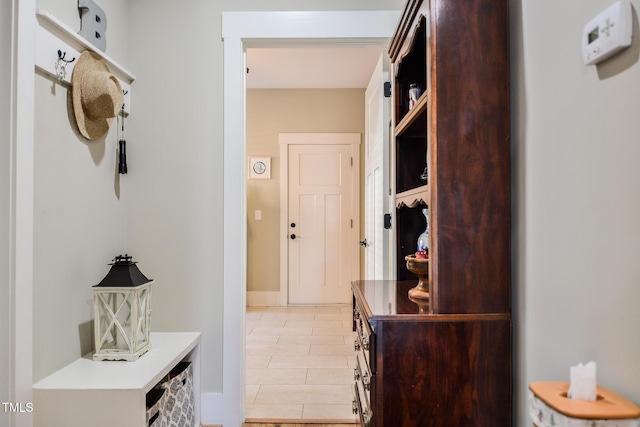 mudroom featuring light tile patterned floors and baseboards