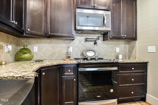 kitchen with electric stove, stainless steel microwave, and dark brown cabinetry