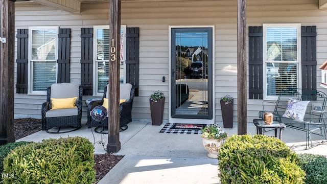 view of exterior entry with covered porch