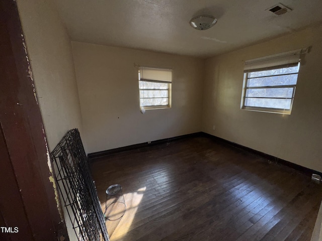 spare room with dark wood-type flooring