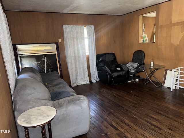 living room with dark wood-type flooring and wood walls