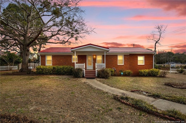 single story home with a lawn