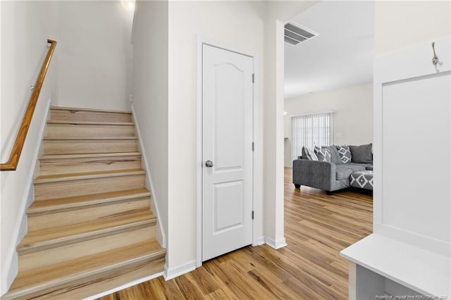 staircase featuring hardwood / wood-style flooring