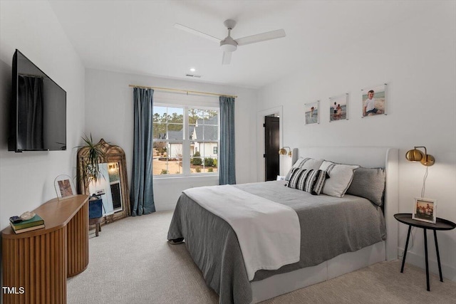 bedroom with light colored carpet and ceiling fan