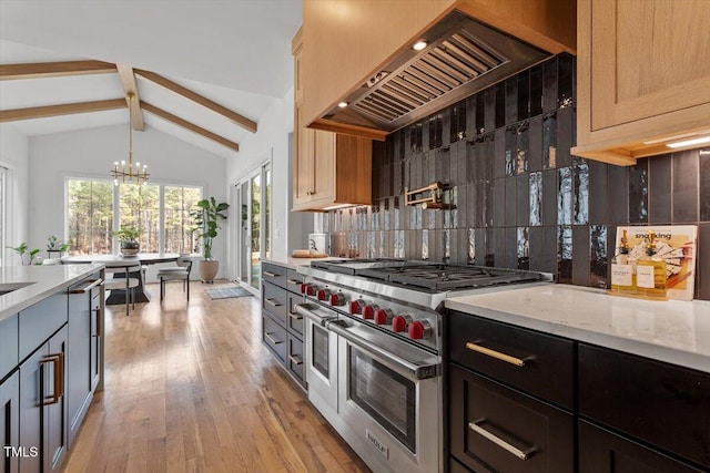 kitchen featuring premium range hood, an inviting chandelier, hanging light fixtures, light brown cabinetry, and range with two ovens