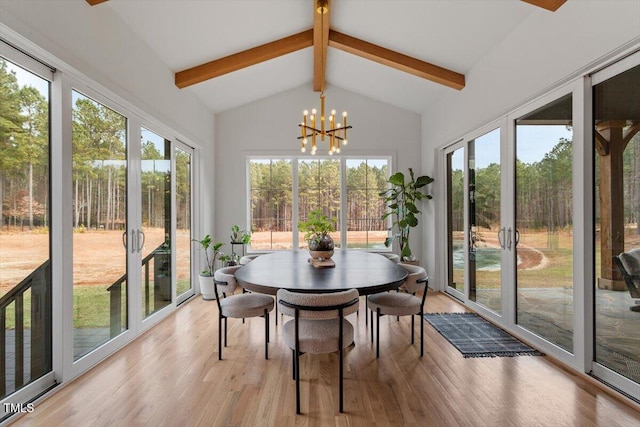 sunroom / solarium with a wealth of natural light, a chandelier, and vaulted ceiling with beams