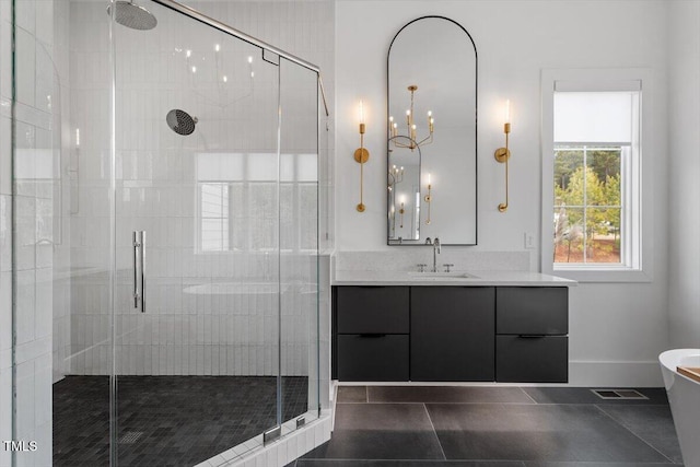 bathroom featuring tile patterned flooring, vanity, and walk in shower