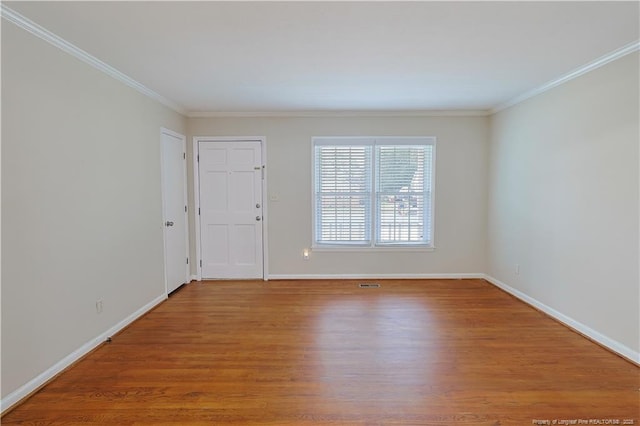 spare room with hardwood / wood-style flooring and ornamental molding