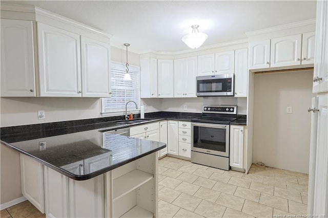 kitchen featuring appliances with stainless steel finishes, sink, pendant lighting, and white cabinets