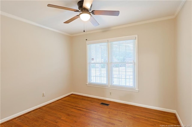 empty room with hardwood / wood-style floors, crown molding, and ceiling fan