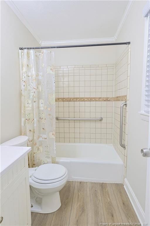 full bathroom featuring shower / tub combo with curtain, hardwood / wood-style flooring, ornamental molding, vanity, and toilet