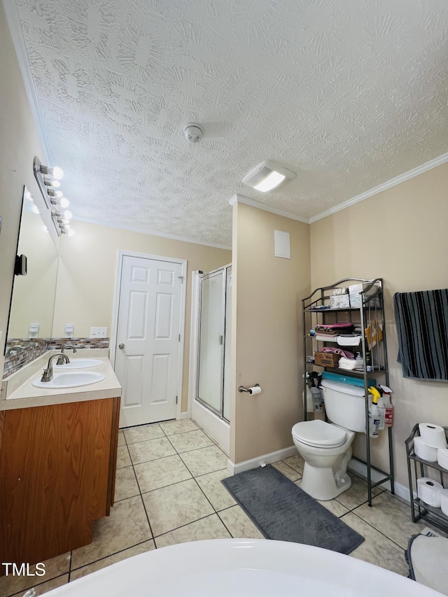 bathroom featuring a textured ceiling, ornamental molding, vanity, a shower with door, and tile patterned flooring