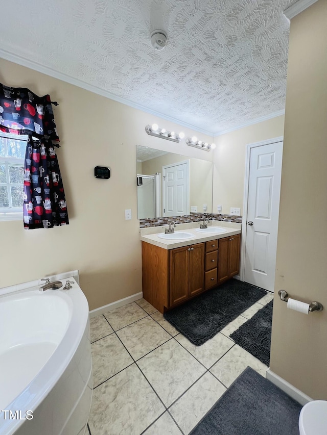 bathroom featuring vanity, ornamental molding, tile patterned floors, and a textured ceiling