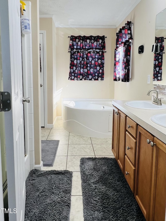 bathroom featuring tile patterned floors, a textured ceiling, ornamental molding, vanity, and a tub