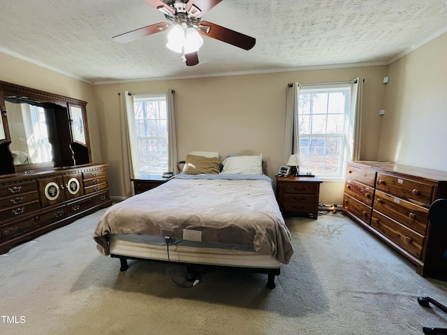 carpeted bedroom with ornamental molding, ceiling fan, and a textured ceiling