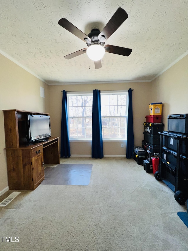 living room featuring ceiling fan, ornamental molding, light carpet, and a textured ceiling