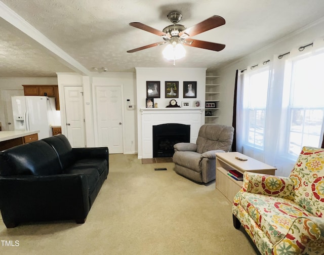 carpeted living room with crown molding, built in features, ceiling fan, and a textured ceiling