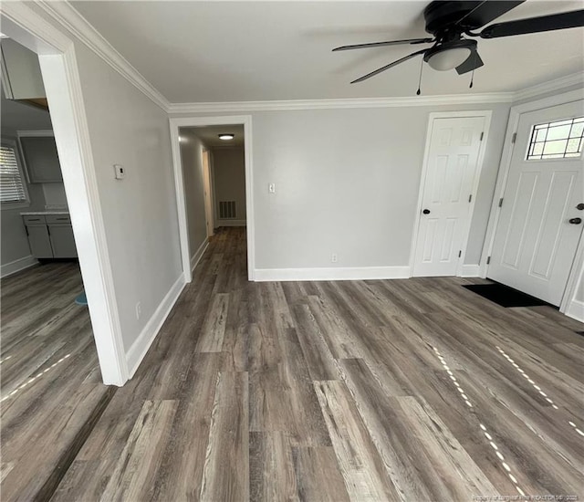 interior space with crown molding, ceiling fan, and dark hardwood / wood-style flooring