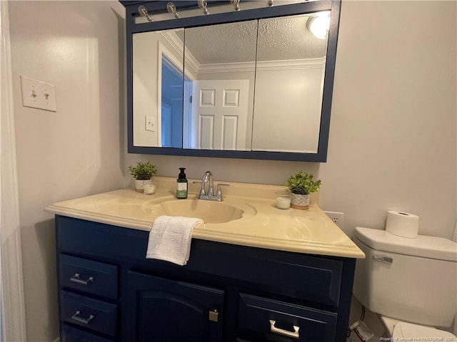 bathroom featuring vanity, a textured ceiling, and toilet