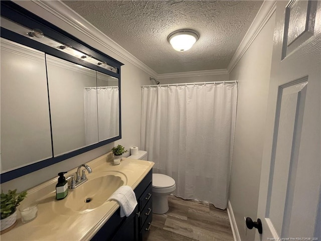 bathroom with toilet, wood-type flooring, a textured ceiling, ornamental molding, and vanity