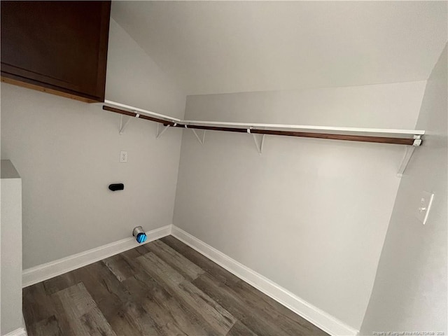 washroom featuring cabinets, electric dryer hookup, and dark wood-type flooring