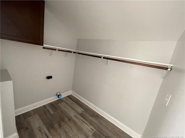 laundry room featuring dark wood-type flooring, cabinets, and electric dryer hookup