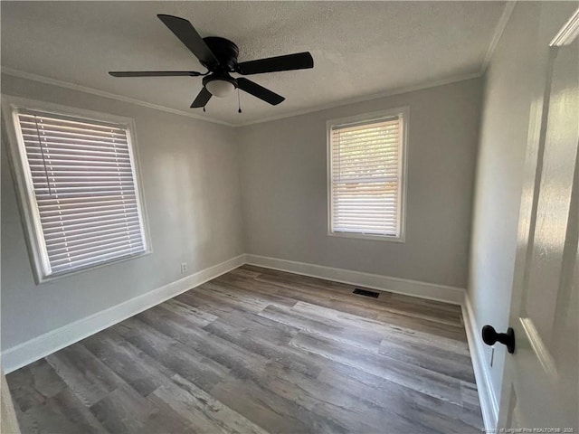 unfurnished room with crown molding, a textured ceiling, and light wood-type flooring