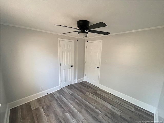 unfurnished room featuring crown molding, dark hardwood / wood-style floors, and ceiling fan