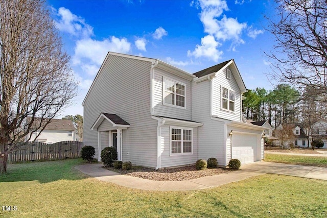 view of property featuring a garage and a front lawn