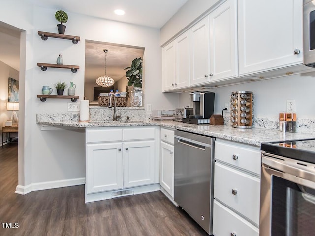 kitchen with stainless steel appliances, sink, pendant lighting, and white cabinets