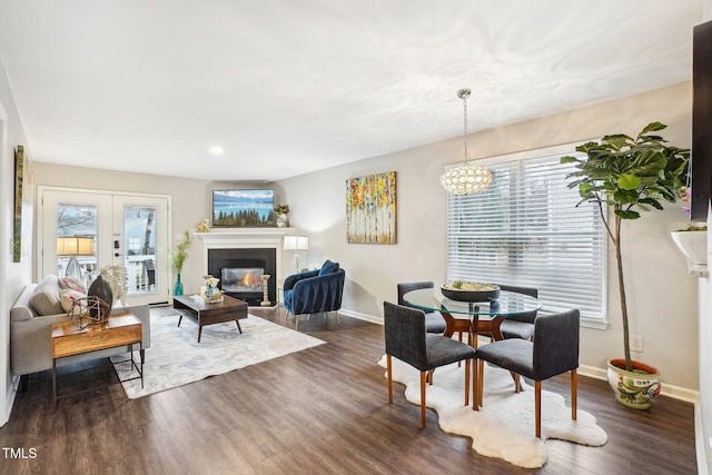 dining room with dark hardwood / wood-style floors and french doors